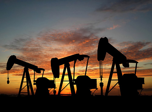 Three pumps over orange sky